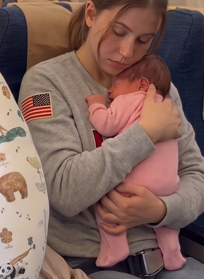 Another mom holds her baby the whole flight