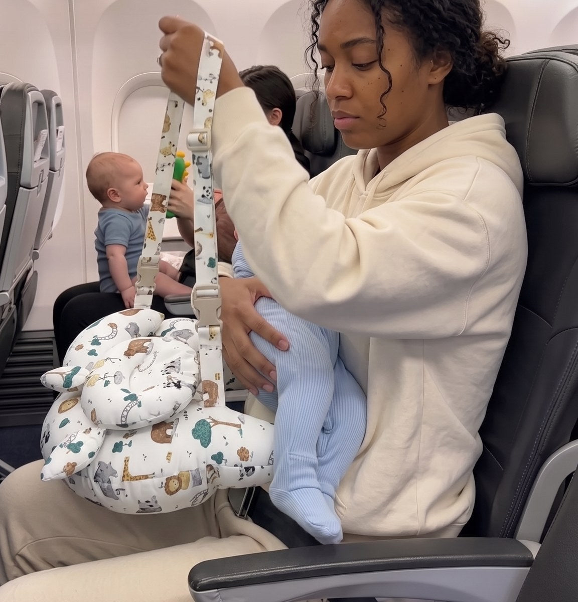 Mom loops the SkyCradle strap over her shoulder
